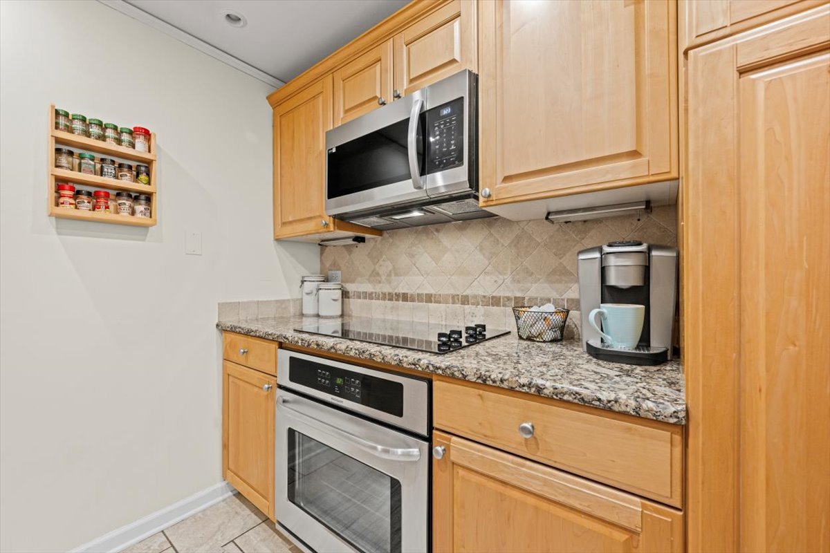 1625 Sheridan Road, Unit 312 Wilmette, IL 60091 - Photo 14 of 24 a kitchen with stainless steel appliances granite countertop a sink and a microwave