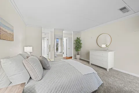 a bedroom with a bed and a potted plant