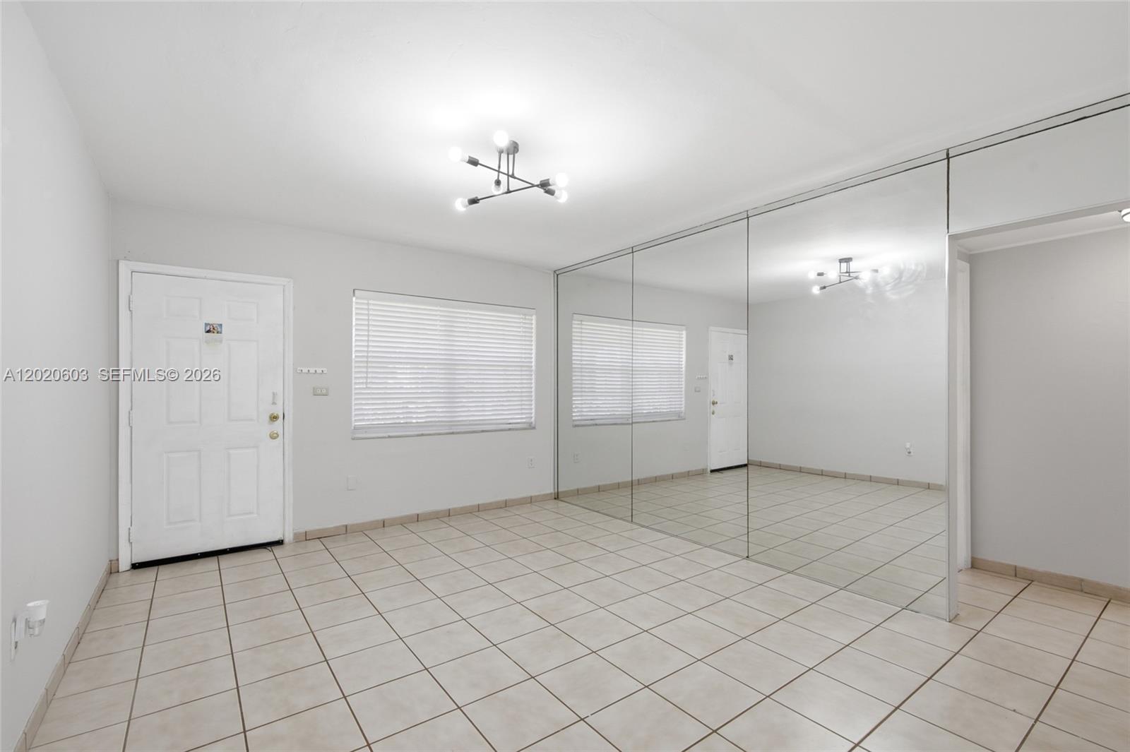 3750 Southwest 27th Street Miami, FL 33134 - Photo 5 of 41 an empty room with chandelier fan and windows