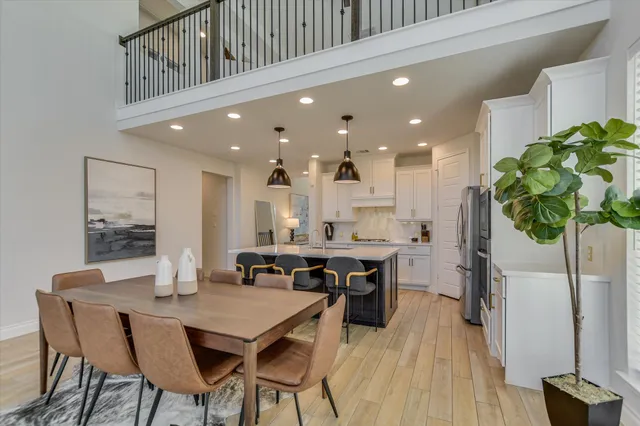 a kitchen with stainless steel appliances granite countertop a sink a stove and a refrigerator