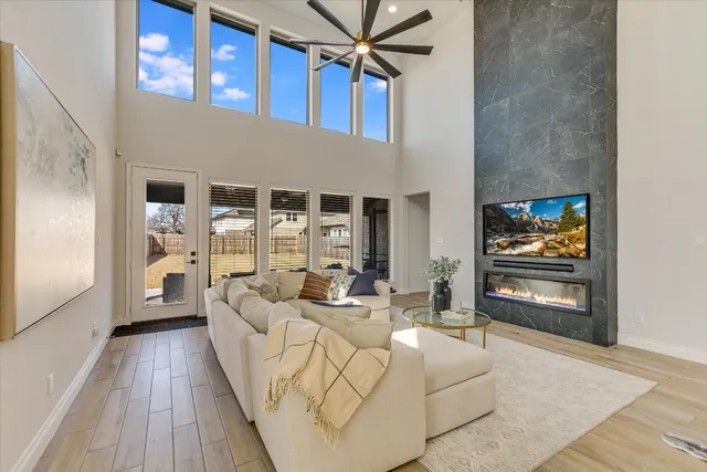 a living room with furniture a flat screen tv and a fireplace