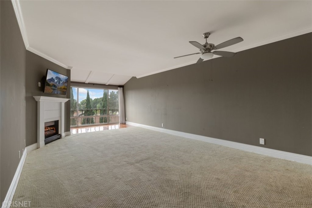 12830 Burbank Boulevard, Unit 316 Valley Village, CA 91607 - Photo 2 of 18 a view of an empty room with a fireplace and a window