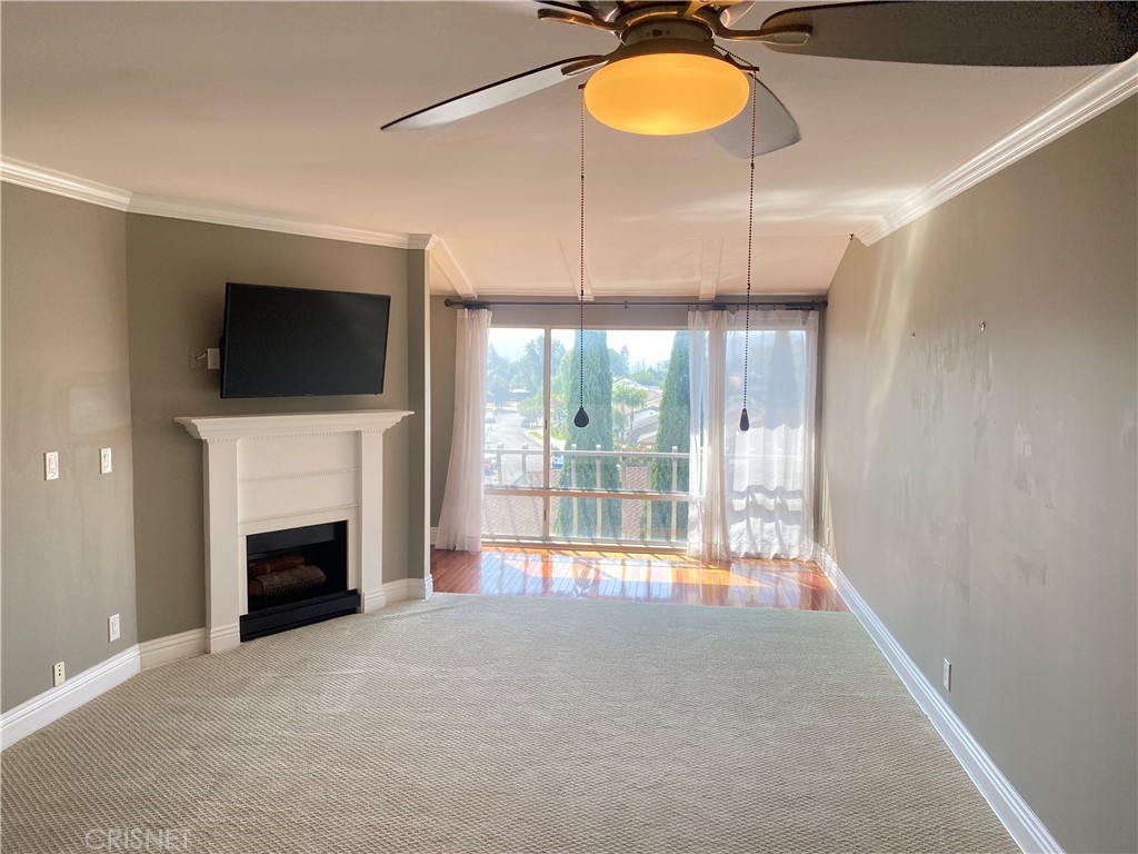 12830 Burbank Boulevard, Unit 316 Valley Village, CA 91607 - Photo 3 of 18 a view of an empty room with a fireplace and a window