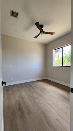 an empty room with a empty space and windows