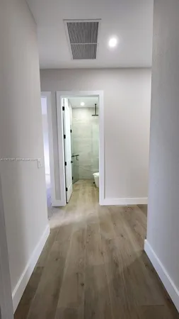 an empty room with an entrance to other room
