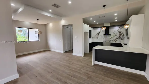 a view of living room with wooden floor and ceiling fan