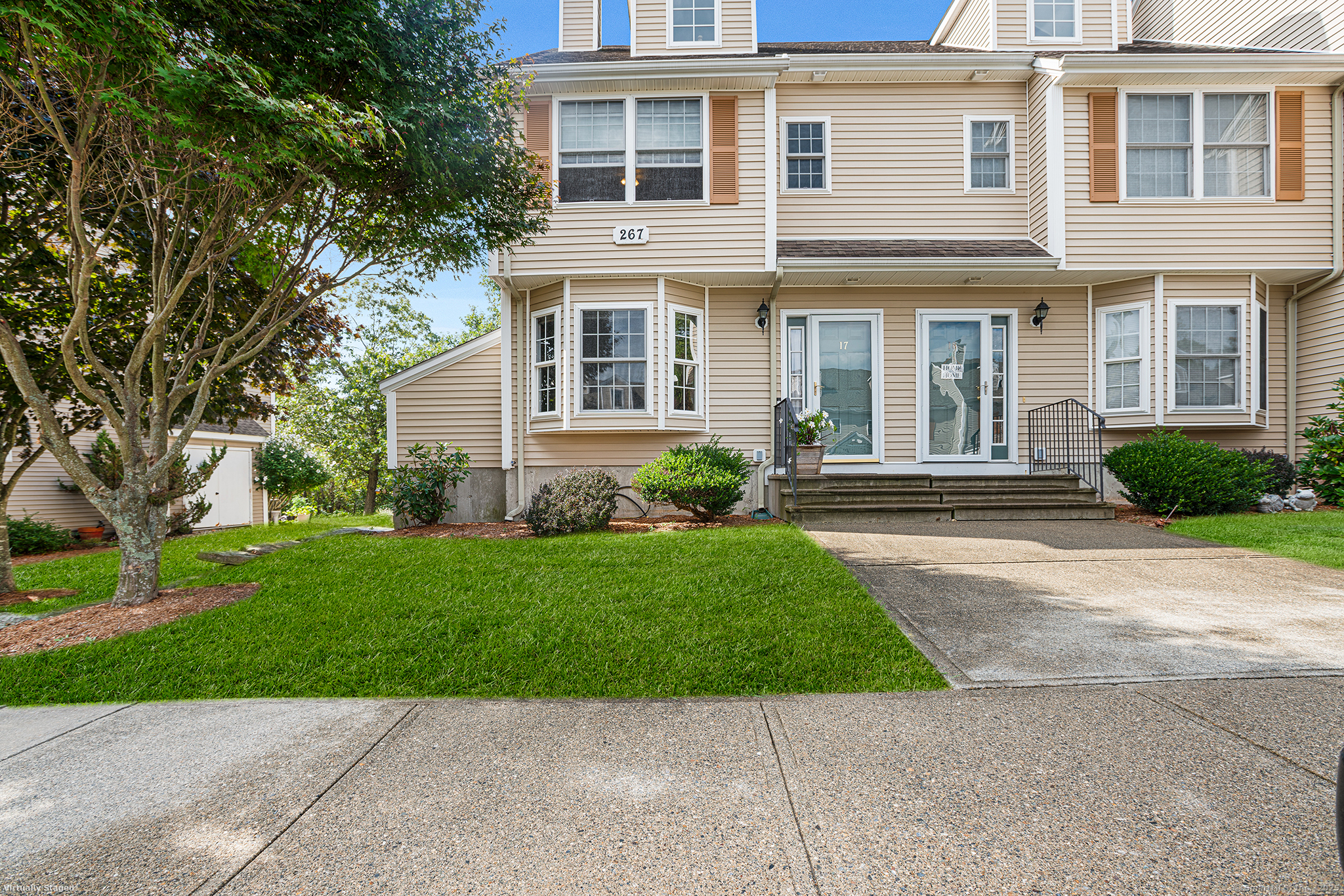 267 Bridge Street, Unit 17 Groton, CT 06340 - Photo 1 of 1 front view of a brick house with a yard