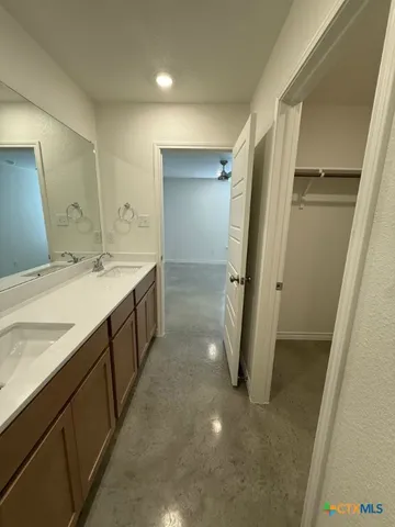 a bathroom with a double vanity sink and a mirror