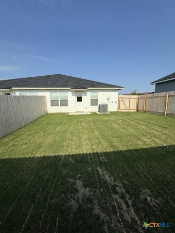 a view of a big yard with an outdoor space