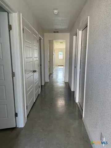 a view of a hallway with wooden floor