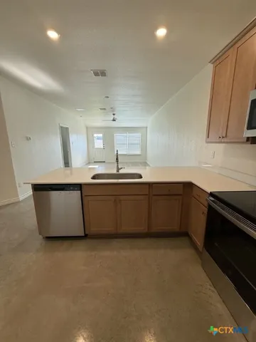 a kitchen with counter top space and stainless steel appliances