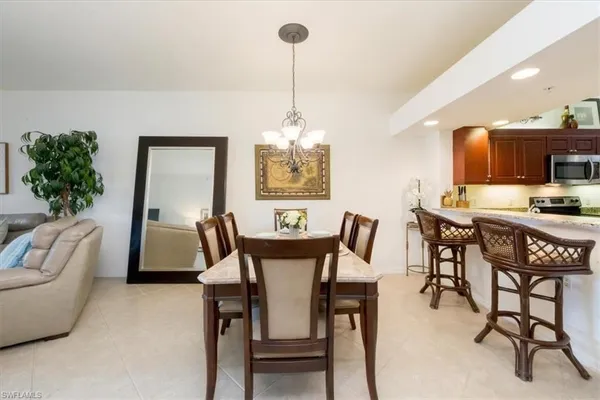 a view of a dining room with furniture and a chandelier