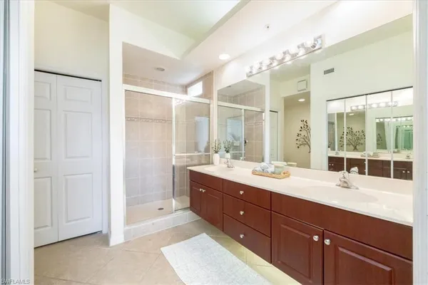 a spacious bathroom with a double vanity sink mirror and double