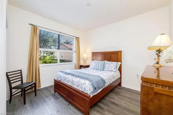 a bed sitting in a bedroom next to a window
