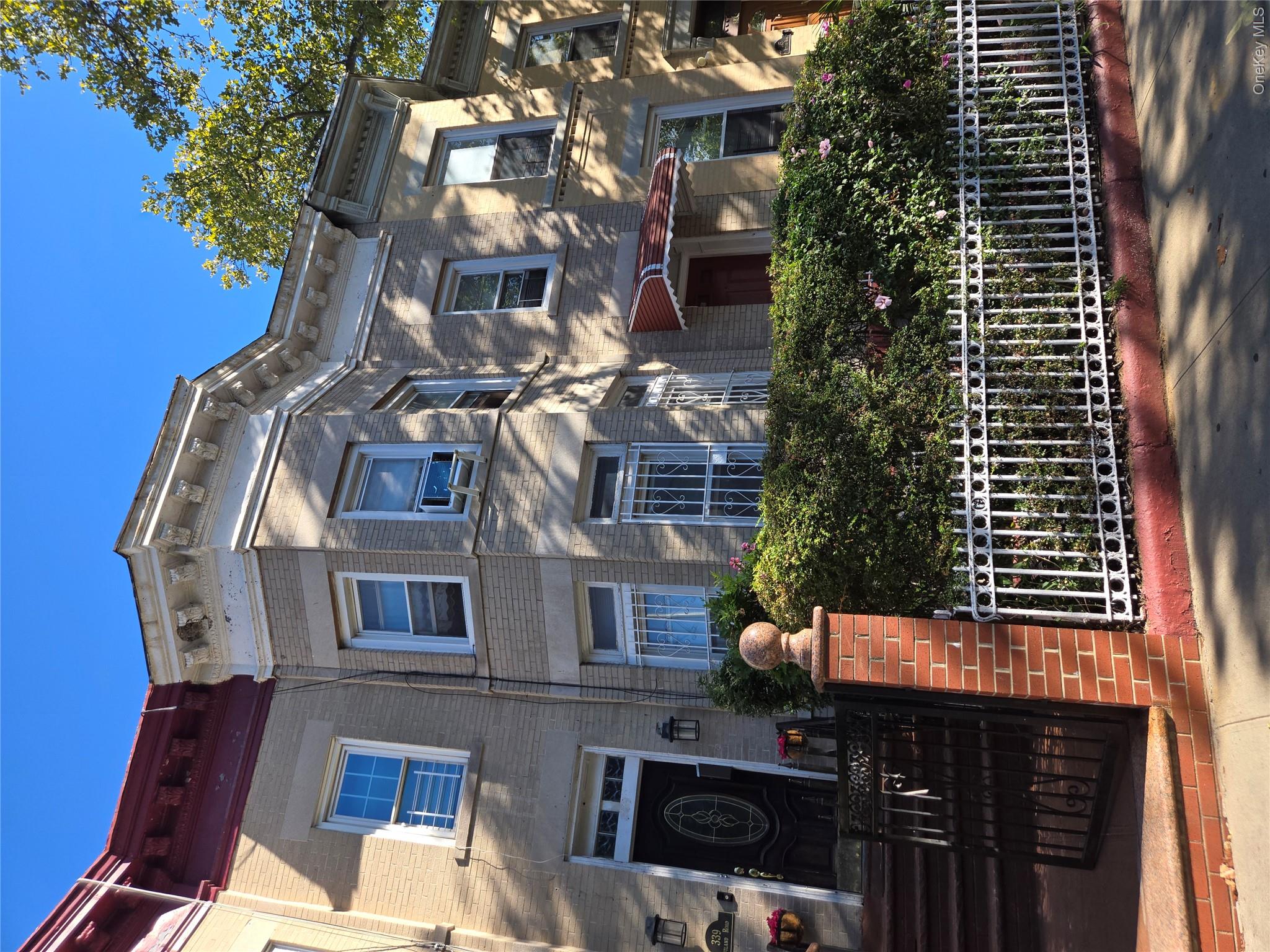 343 Rutland Road Brooklyn, NY 11225 - Photo 1 of 17 Italianate-style house with brick siding and a fenced front yard