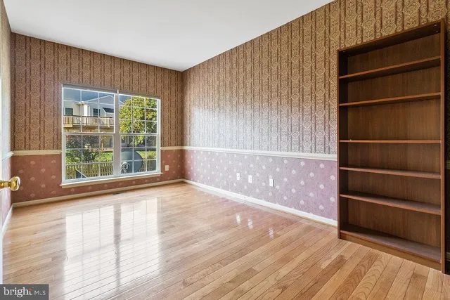 a view of wooden floor and windows in a room