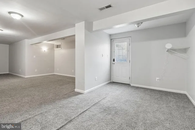 a view of a room with wooden floor
