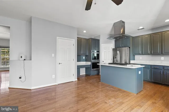 a kitchen with stainless steel appliances a refrigerator sink and cabinets