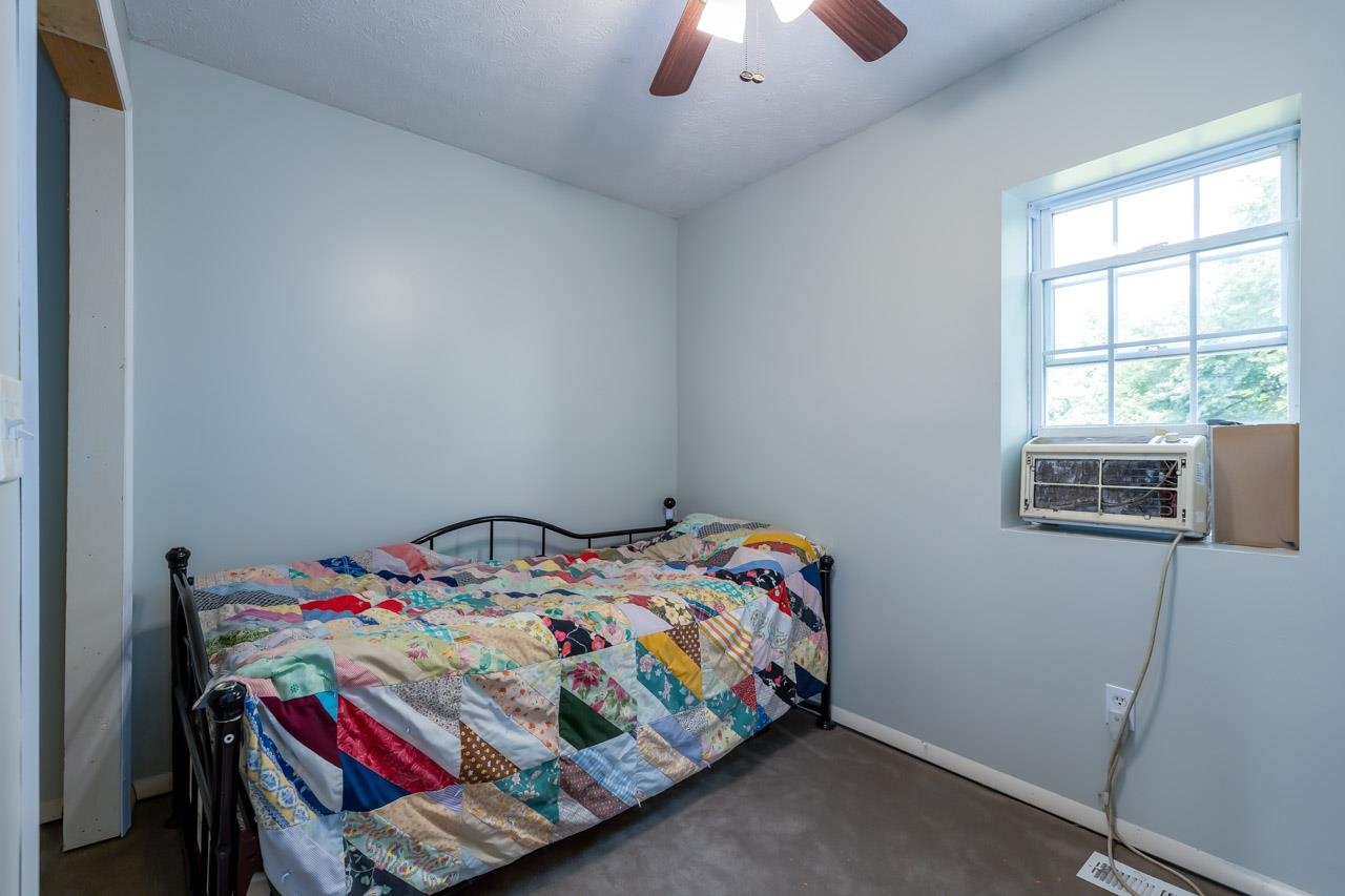 4147 South Middle Road Quicksburg, VA 22847 - Photo 18 of 33 a bedroom with a bed that has a blanket on it and a window
