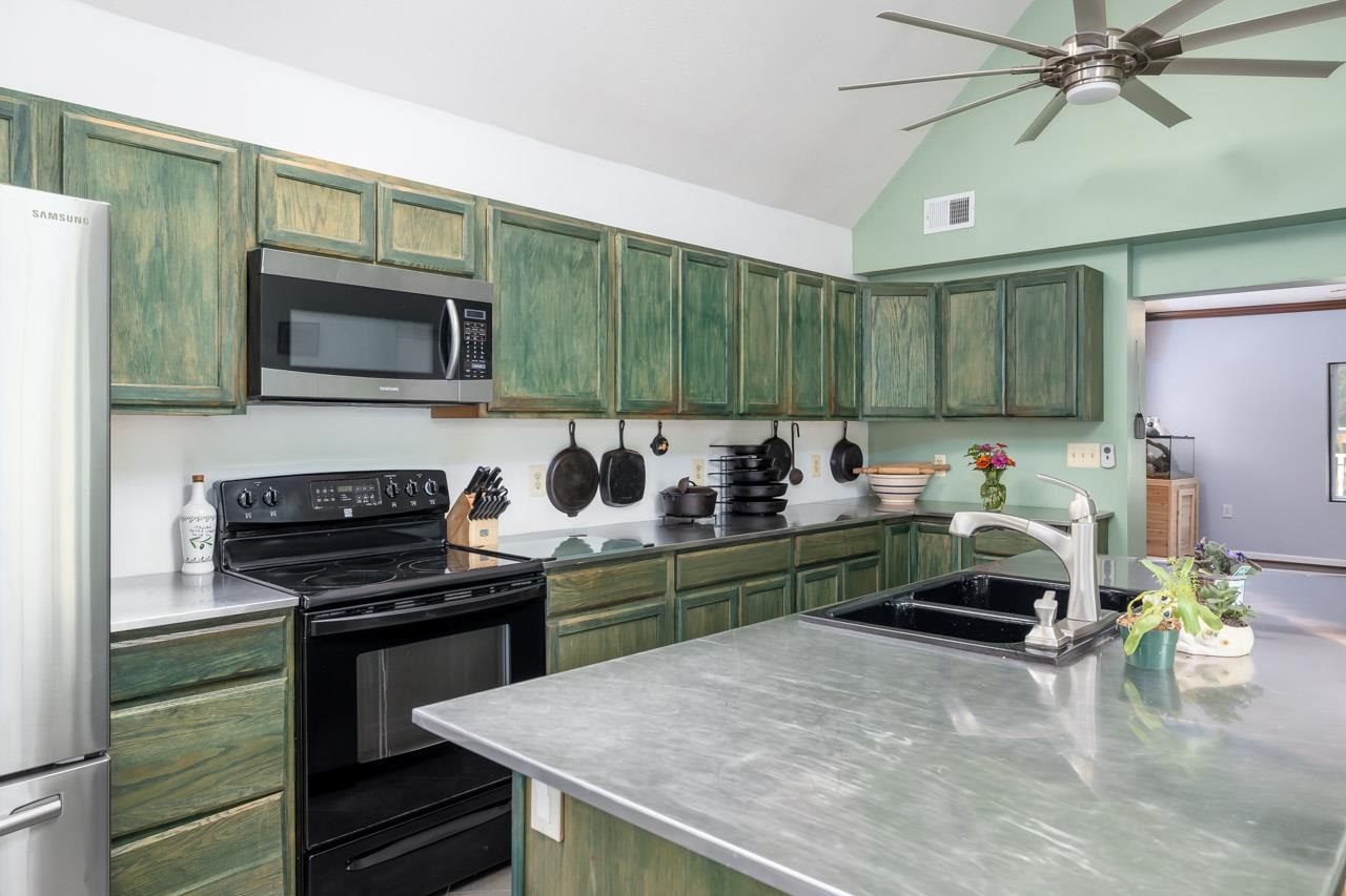 4147 South Middle Road Quicksburg, VA 22847 - Photo 3 of 33 a kitchen with stainless steel appliances a stove a sink and a microwave