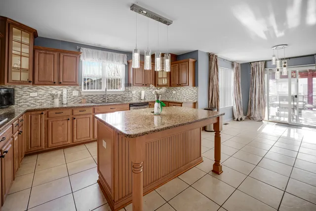 a kitchen with stainless steel appliances granite countertop a sink and a counter