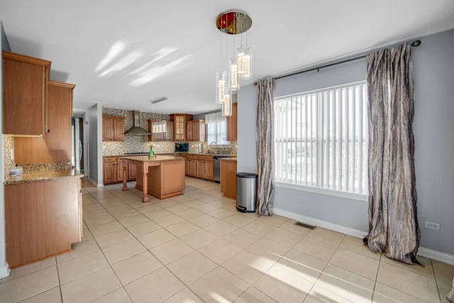 a kitchen with refrigerator and cabinets