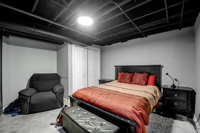 a bedroom with a bed a couch and a dresser