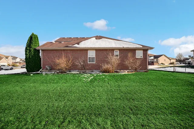 a view of a house with a yard and plants