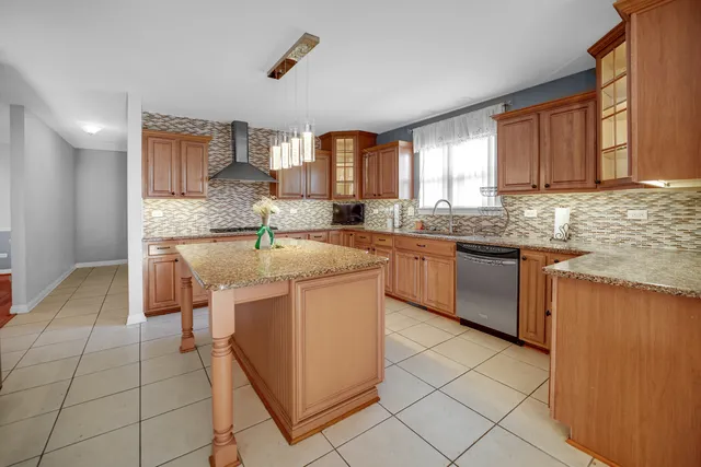 a kitchen with stainless steel appliances granite countertop a sink stove and cabinets