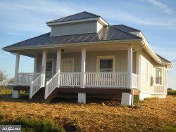a view of a house with a wooden fence