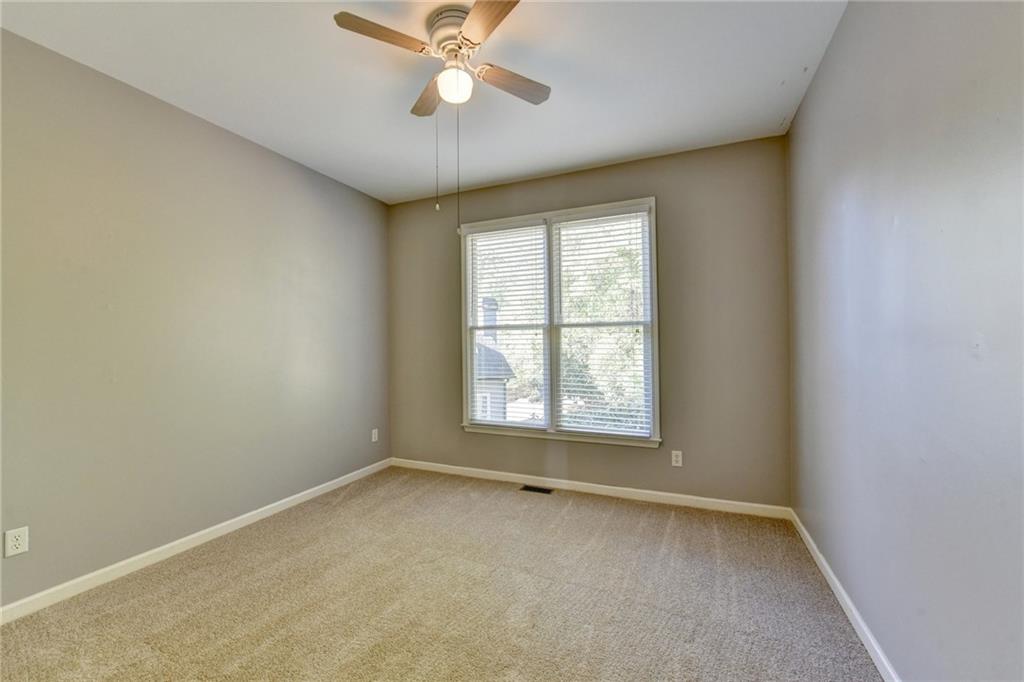 3407 Highland Forge Trail Dacula, GA 30019 - Photo 23 of 71 an empty room with a window and a fan