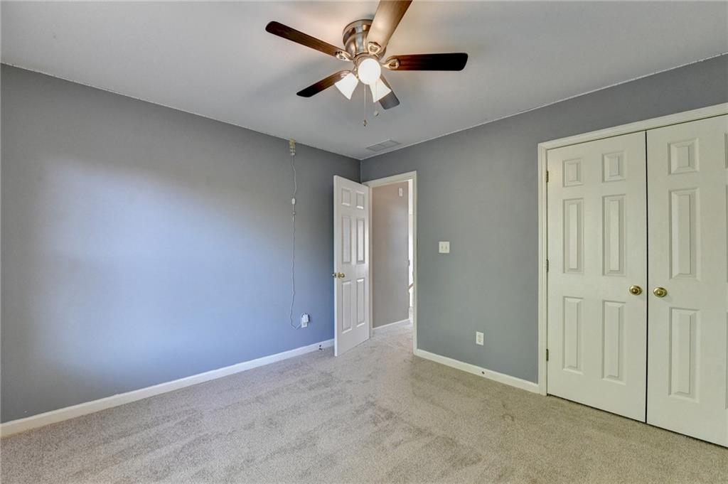 3407 Highland Forge Trail Dacula, GA 30019 - Photo 29 of 71 an empty room with closet and a chandelier fan