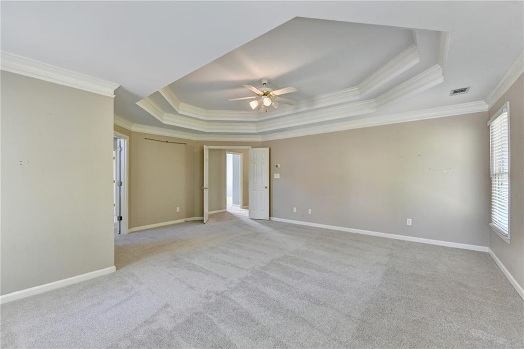 3407 Highland Forge Trail Dacula, GA 30019 - Photo 31 of 71 an empty room with a ceiling fan and a window