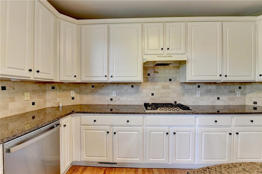 3407 Highland Forge Trail Dacula, GA 30019 - Photo 36 of 71 a kitchen with granite countertop white cabinets and stainless steel appliances