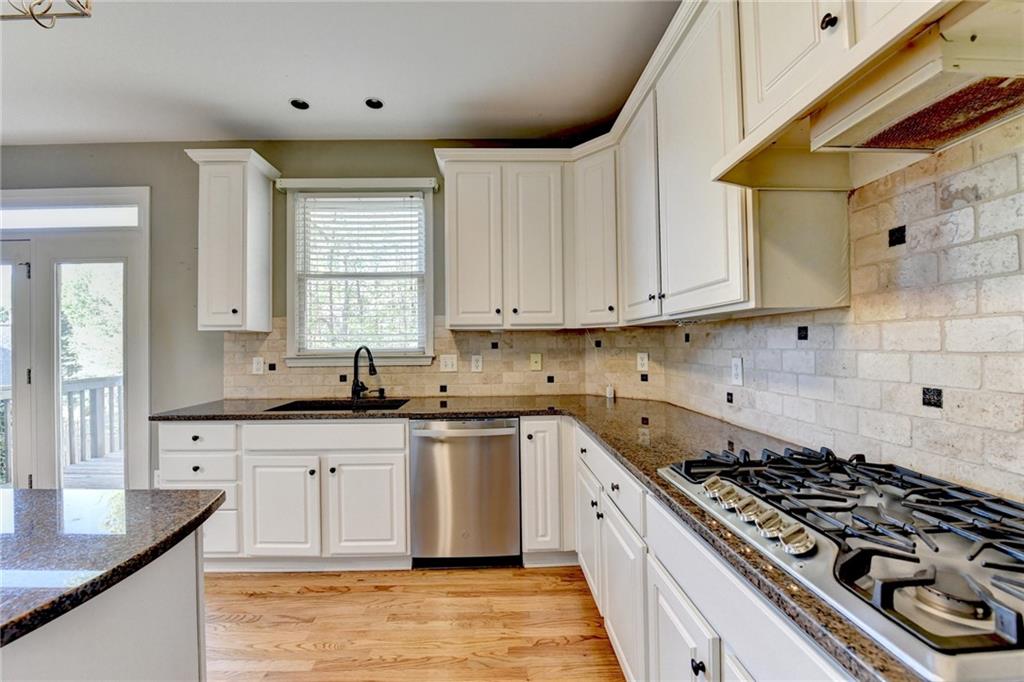 3407 Highland Forge Trail Dacula, GA 30019 - Photo 38 of 71 a kitchen with stainless steel appliances a sink dishwasher stove and refrigerator