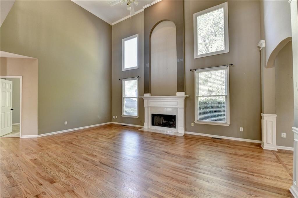3407 Highland Forge Trail Dacula, GA 30019 - Photo 41 of 71 an empty room with windows fire place and windows