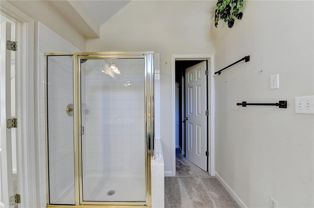 3407 Highland Forge Trail Dacula, GA 30019 - Photo 62 of 71 a view of a bathroom with a glass shower door