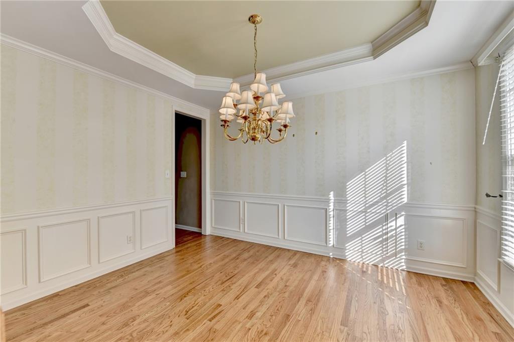 3407 Highland Forge Trail Dacula, GA 30019 - Photo 10 of 71 a view of an empty room with wooden floor and windows