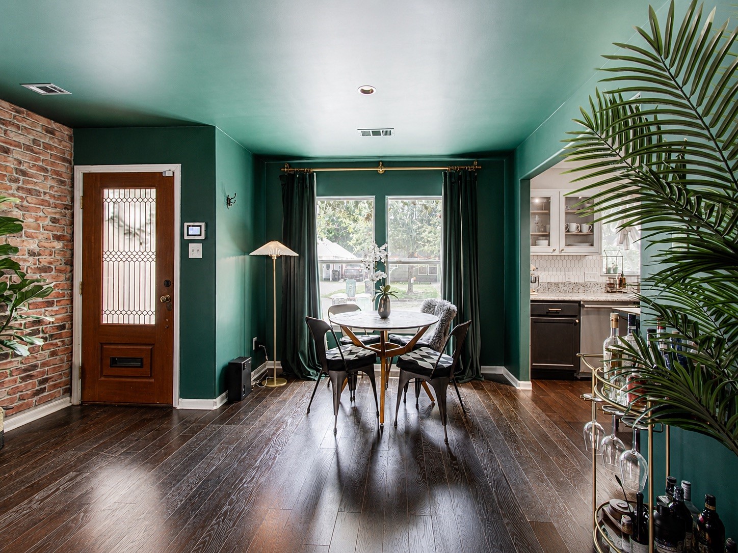 8647 Suburban Oaks Road Houston, TX 77093 - Photo 2 of 21 Natural light carries through the living area toward the front entry and adjacent dining space. (photo has been enhanced for marketing purposes)