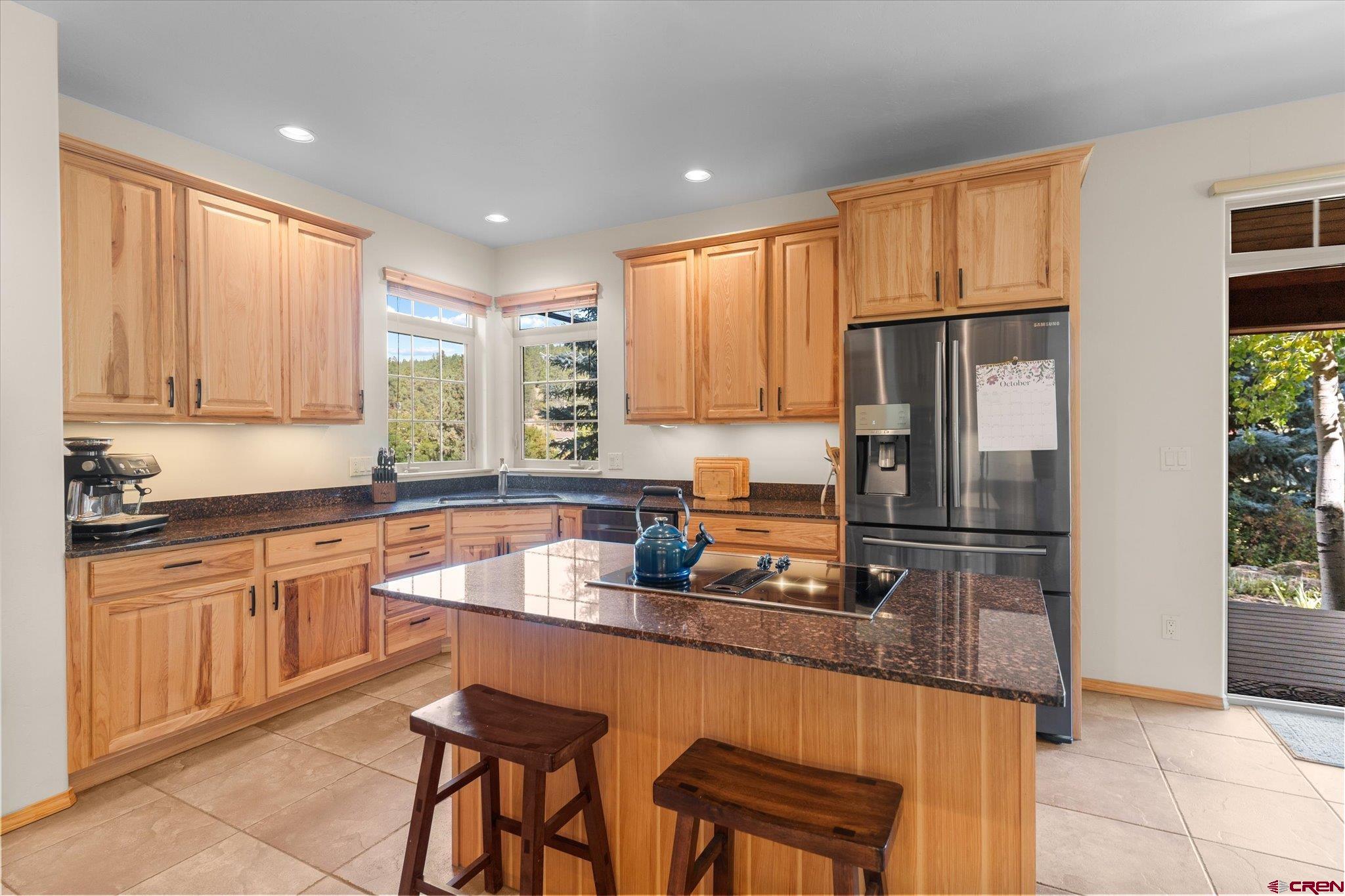 73 Ute Pass Road Durango, CO 81301 - Photo 12 of 44 a kitchen with stainless steel appliances granite countertop a refrigerator a sink a stove a dining table and chairs