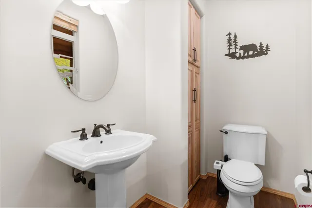 a bathroom with a toilet sink and mirror