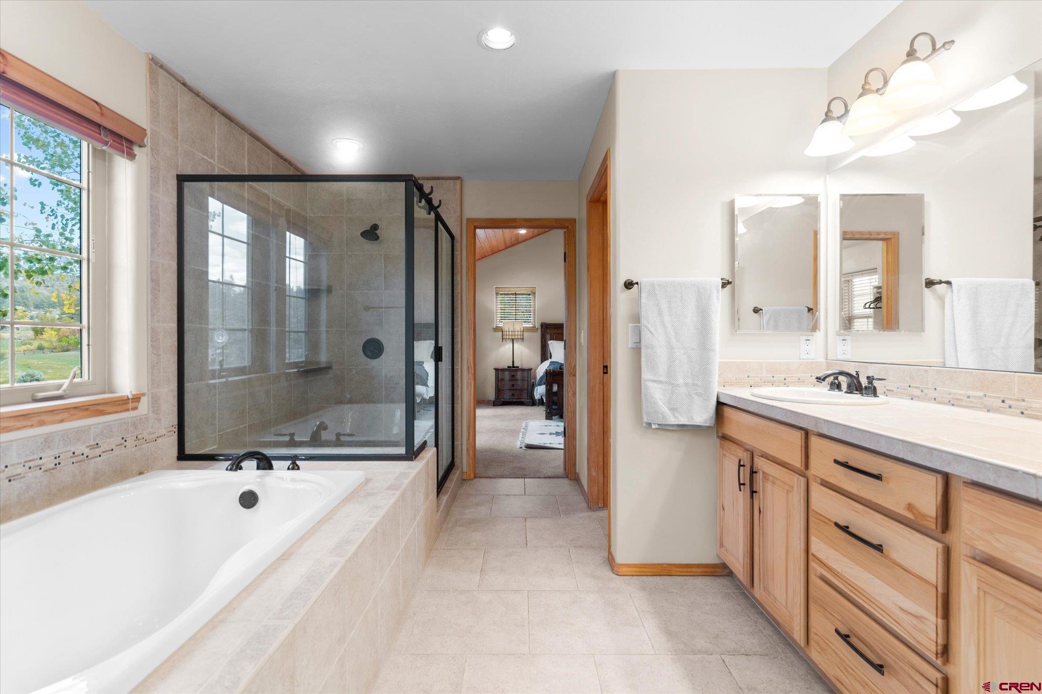 73 Ute Pass Road Durango, CO 81301 - Photo 22 of 44 a spacious bathroom with a bathtub shower and sink