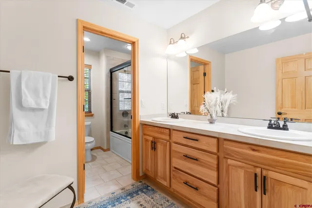 a bathroom with a double vanity sink mirror and