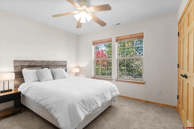 a bedroom with a large bed and a window