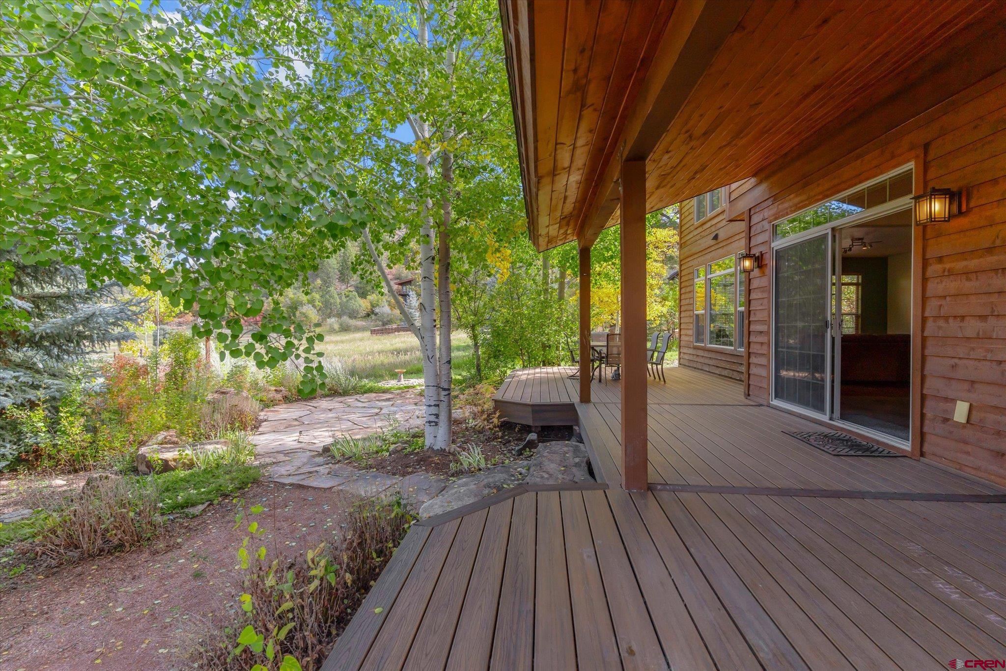 73 Ute Pass Road Durango, CO 81301 - Photo 33 of 44 a view of a patio with table and chairs and wooden floor