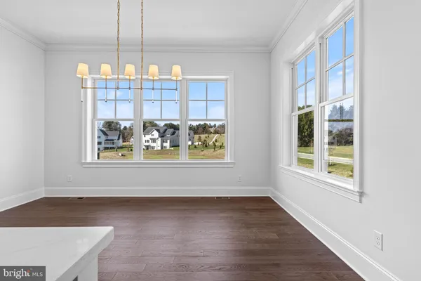 a view of wooden floor and windows in a room