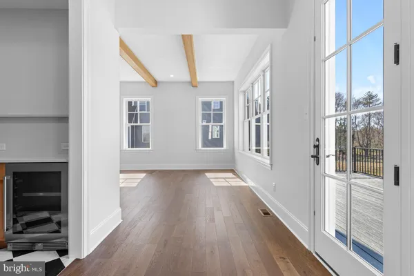 a view of an entryway with wooden floor and a fireplace