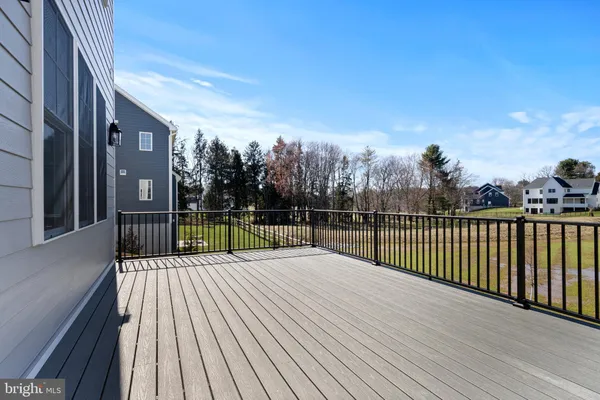 a view of a balcony with wooden floor and fence