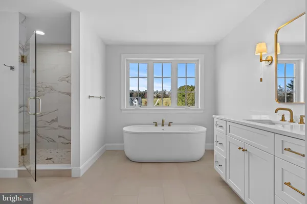 a bathroom with a bathtub sink and mirror