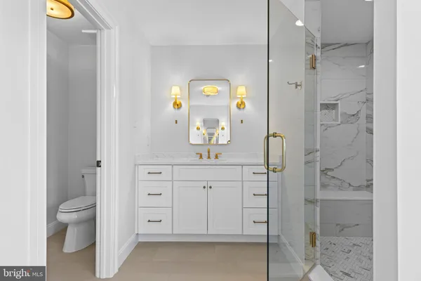 view of bathroom with a toilet sink and mirror